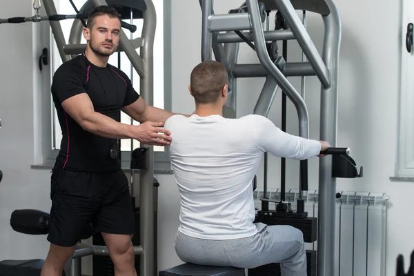 Gym Coach Helping Young Man On Back Exercise — Stock Photo, Image