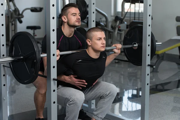 Gym Coach Helping Man On Barbell Squat — Stock Photo, Image