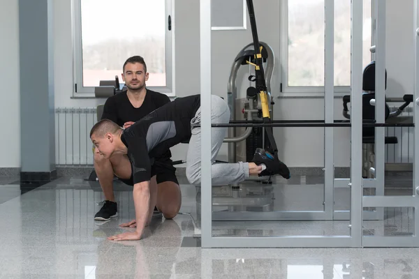 stock image Gym Coach Helping Man On Trx Fitness Straps