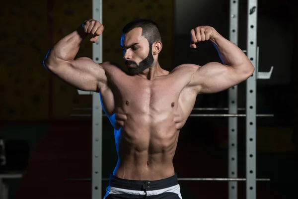 Bodybuilder Performing Front Double Biceps Pose — Stock Photo, Image