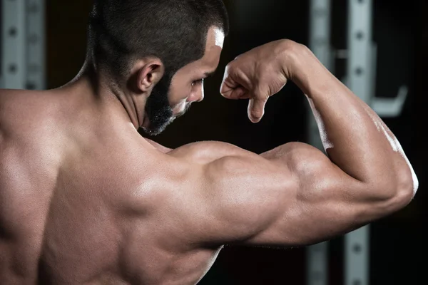 Mladá kulturista protahování svalů Biceps pozice — Stock fotografie