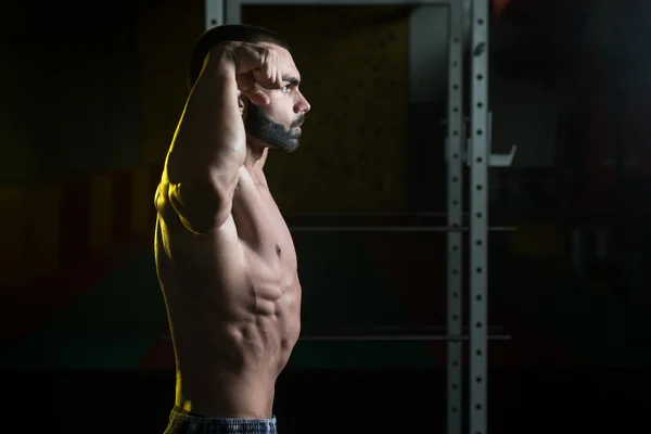 Mladá kulturista, protahuje svaly dvojitý Biceps pozice — Stock fotografie