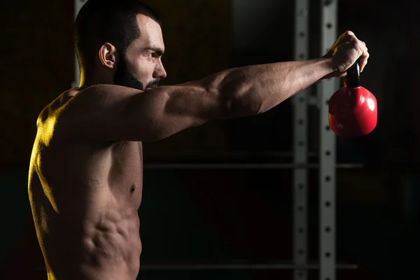Fitness Man met behulp van Kettlebells binnenkant sportschool — Stockfoto