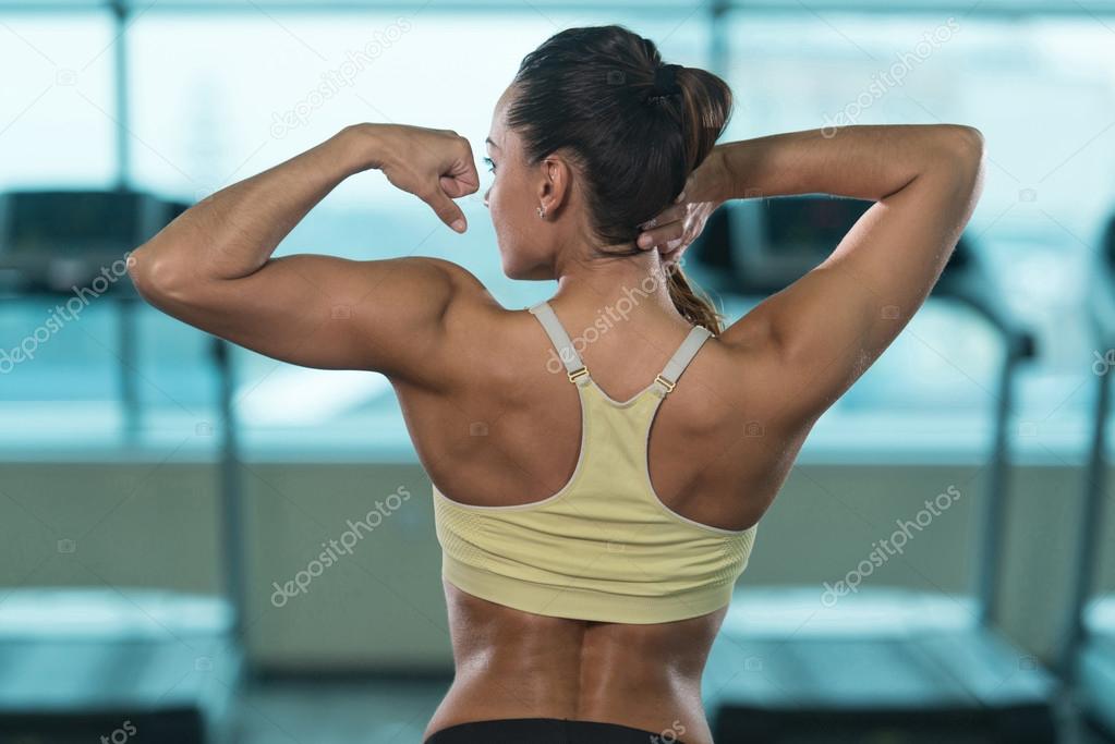 Healthy Young Woman Flexing Muscles Stock Photo by ©ibrak 114120308
