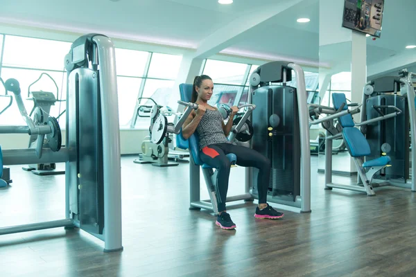 Young Sexy Fitness Woman Exercise Biceps On Machine — Stock Photo, Image