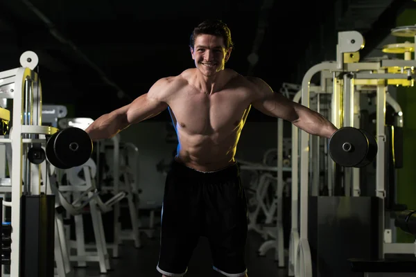 Young Man With Dumbbells Exercising Shoulders — Stock Photo, Image