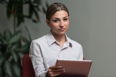 Young Woman Working On Touchpad In Office