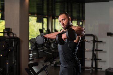 Çalışma salonunda omuzlar dışarı vücut geliştirmeci