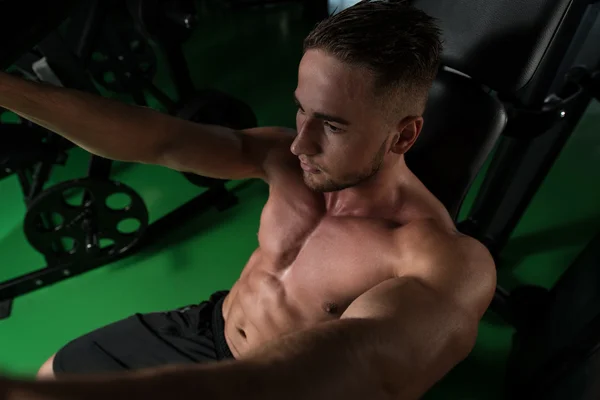 Young Man Exercise Chest On Machine — Stock Photo, Image