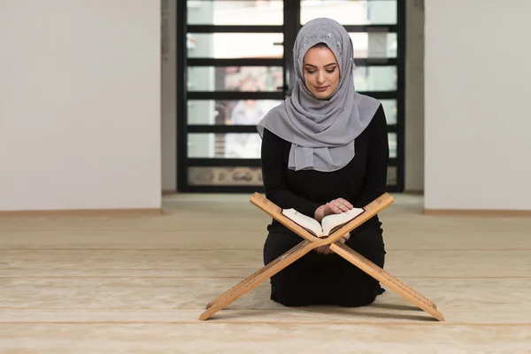 Jonge vrouw lezen van de koran in de moskee — Stockfoto