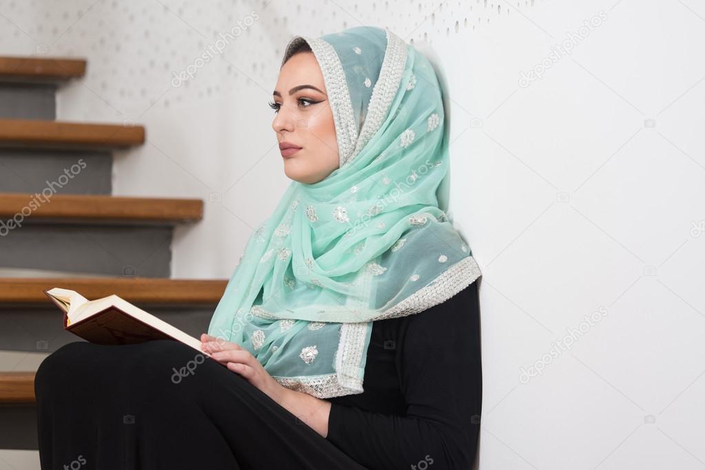 Woman Praying In Mosque And Reading The Quran