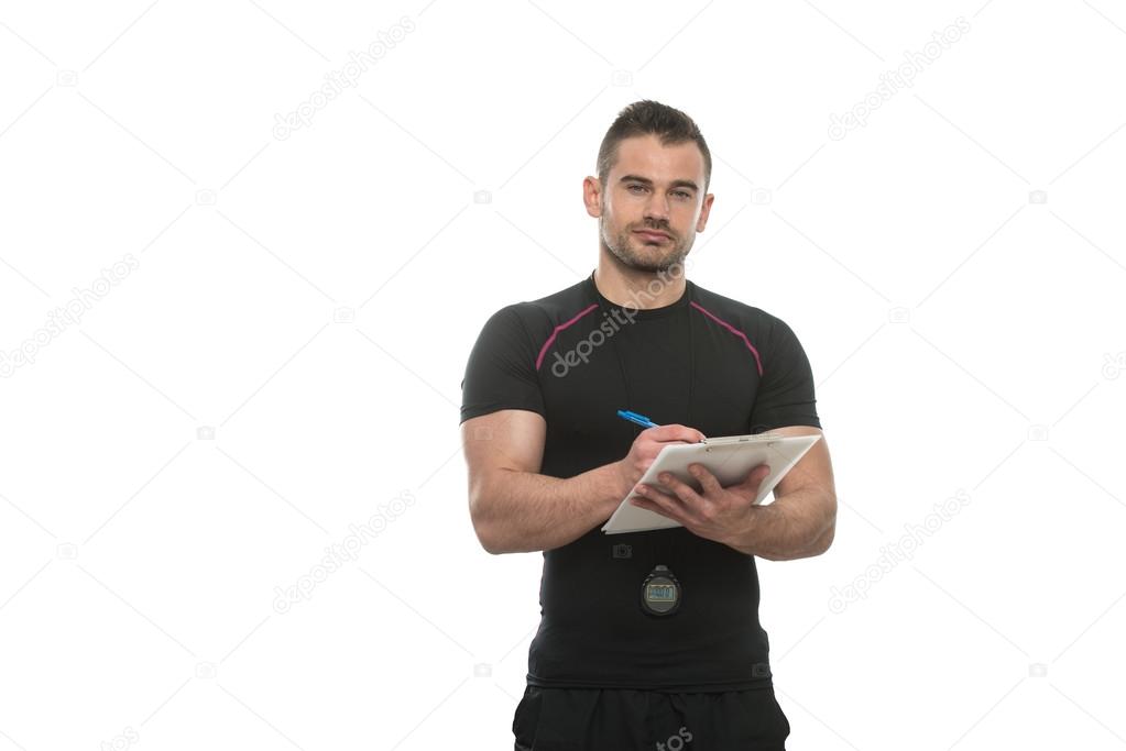 Personal Trainer Takes Notes On Clipboard White Background