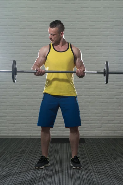 Biceps Exercise With Barbell On White Bricks Background — Stock Photo, Image