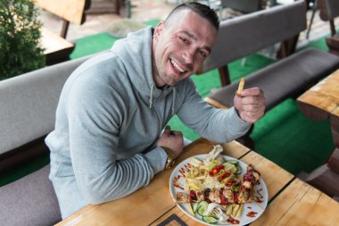 Man tavuk pilav ile açık restoranda yemek