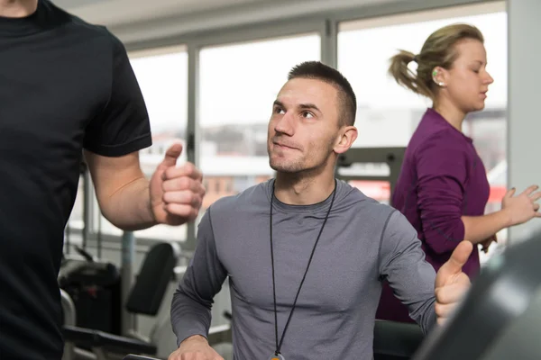 Grupo de personas corriendo en cintas de correr en el gimnasio — Foto de Stock