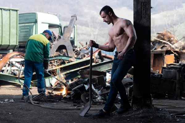 Handsome Man Standing Strong Scrap Metal Industrial Junkyard Flexing Musclesw — Stock Photo, Image