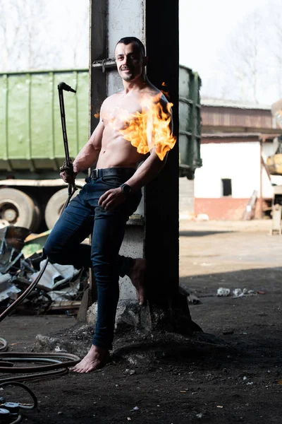 Young Man Athlete Welder is Holds the Gas Torch in His Hand the Fire and the Flame Burns From the Nozzle