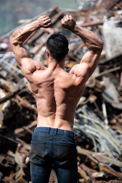 Handsome Man Standing Strong Scrap Metal Industrial Junkyard Flexing Muscles — Stock fotografie
