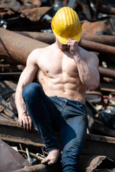 Portrait Young Physically Fit Man Sitting Industrial Junk Yard Showing — Stock Photo, Image