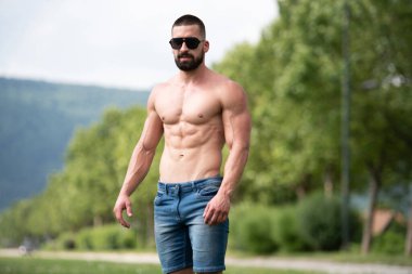 Yakışıklı Sakallı Adam Güçlü Duruyor ve Dışarda Pozisyon Veriyor Yaprakların Arkaplan Doğası