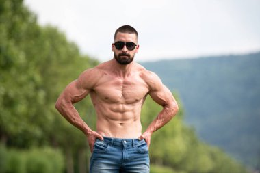 Yakışıklı Sakallı Adam Güçlü Duruyor ve Dışarda Pozisyon Veriyor Yaprakların Arkaplan Doğası