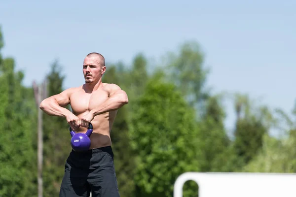 Man Working Out With Kettle Bell Outdoors - Bodybuilder Doing Heavy Weight Exercise With Kettle-bell