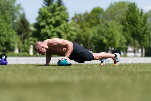 Zdrowy Człowiek Sportowiec Robi Pompki Trening Kettle Bell Zewnątrz Kettle — Zdjęcie stockowe
