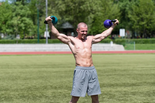 Man Working Out With Kettle Bell Outdoors - Bodybuilder Doing Heavy Weight Exercise With Kettle-bell