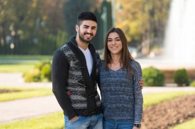 Portrait of a Beautiful Couple Enjoying Fall in the Park Outside During Autumn