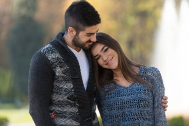 Portrait of a Beautiful Young Couple Relaxing in Park