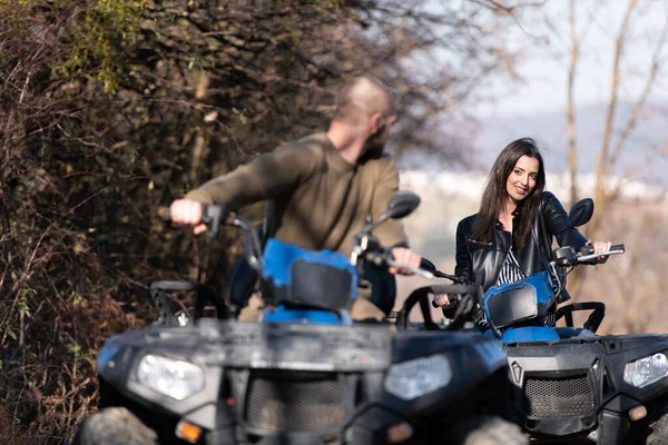 Couple Riding on Atv Bike or Quad Bike on Road Along Forest Trail on Mountain