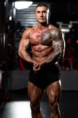 Fiziksel olarak fit bir adamın portresi iyi eğitilmiş vücudunu gösteriyor kaslı atletik vücut geliştirici egzersiz sonrası spor modelliği pozu