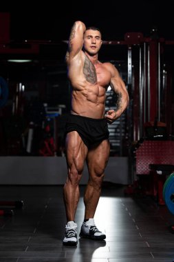 Fiziksel olarak fit bir adamın portresi iyi eğitilmiş vücudunu gösteriyor kaslı atletik vücut geliştirici egzersiz sonrası spor modelliği pozu