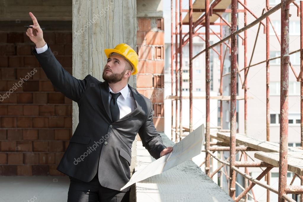 Businessman Pointing On Ceiling