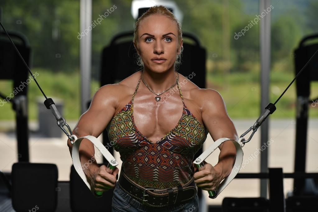 Premium Photo  Woman bodybuilder is working on her chest with cable  crossover in gym