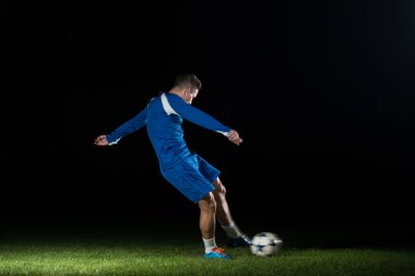 futbol oyuncusu tekme ile topu yapıyor