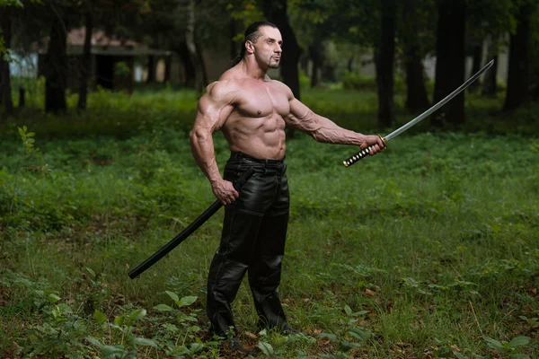 Portrait Of A Muscular Ancient Warrior With Sword — Stock Photo, Image