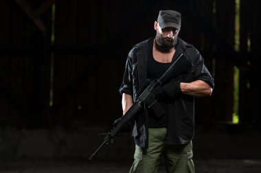 Sakallı adam bir makineli tüfek ile