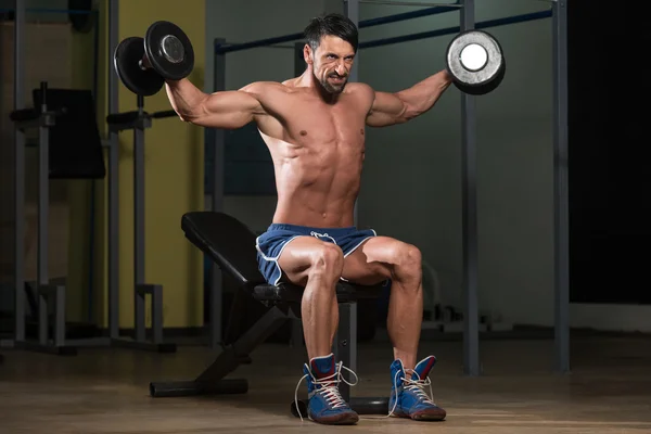 Bodybuilder Exercising Shoulders With Dumbbells — Stock Photo, Image