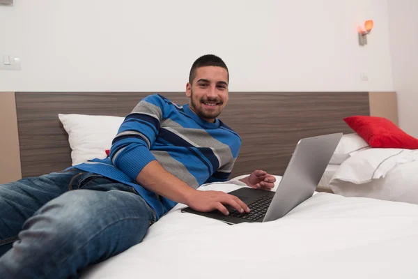 Happy Young Man Using Laptop On Bed — Stock Photo, Image