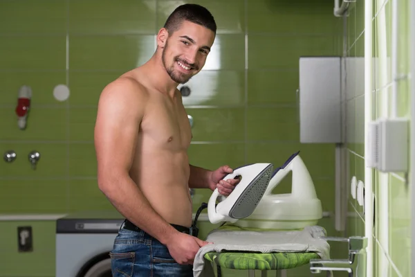 Naked Man Ironing Clothes In A Utility Room — Stock Photo, Image