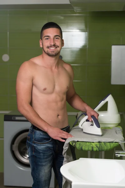 Naked Man Ironing Clothes In A Utility Room — Stock Photo, Image