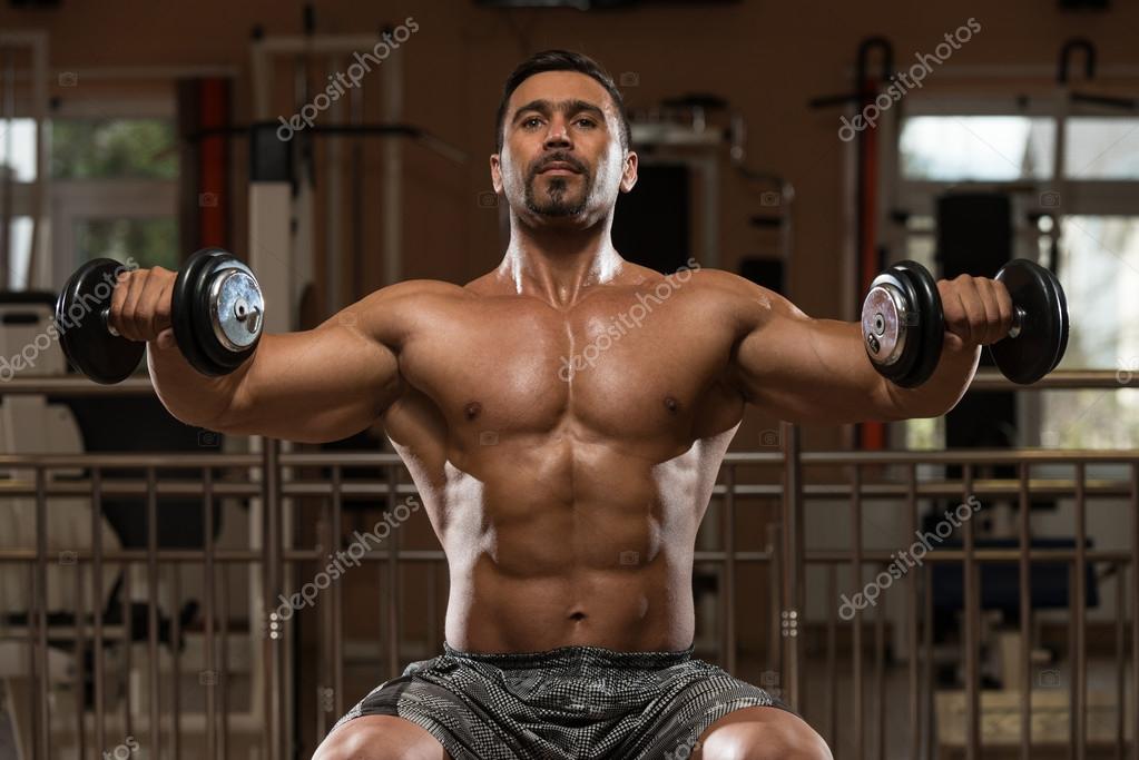 Handsome Muscular Fitness Bodybuilder Doing Heavy Weight Exercise