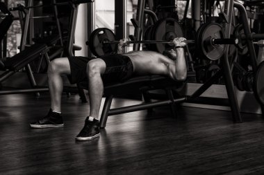 Barbell ile göğüs için egzersiz yapan genç erkek