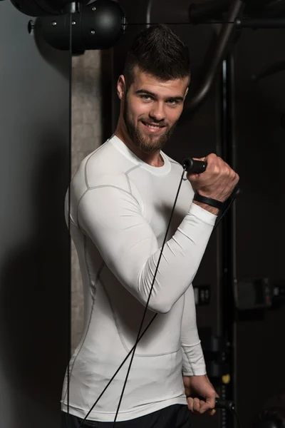 Young Man Exercising Biceps On Machine — Stock Photo, Image