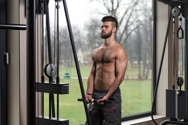 Young Man Exercising Biceps On Machine — Stock Photo, Image