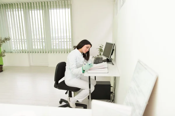 Dentist Assistant Writes Some Notes In Medical Book — Stock Photo, Image