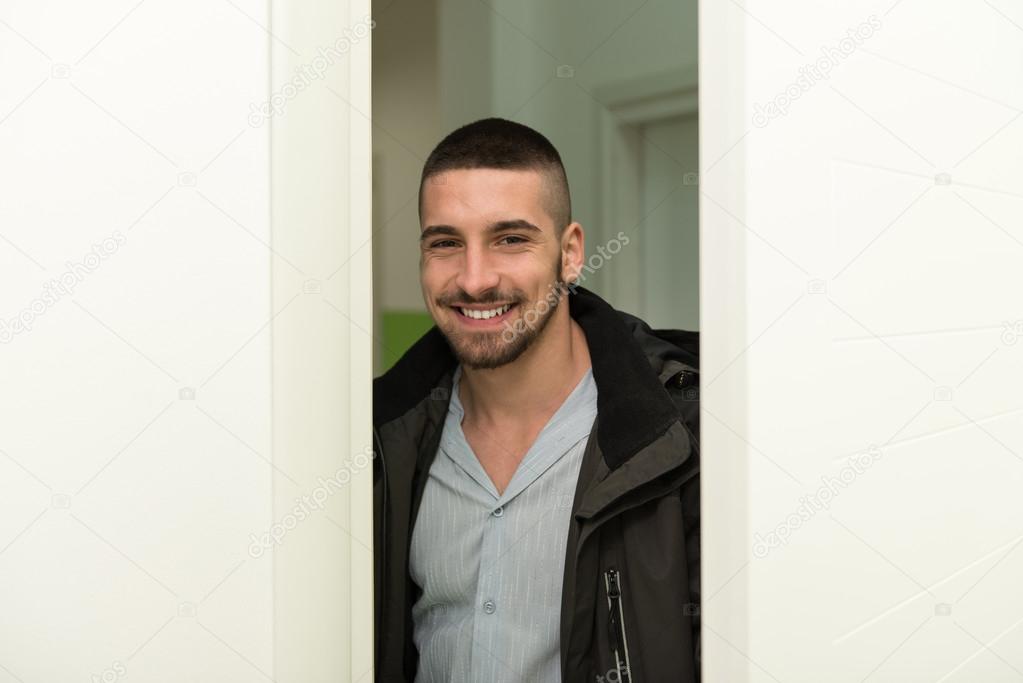 Young Man Entering Through His Front Door