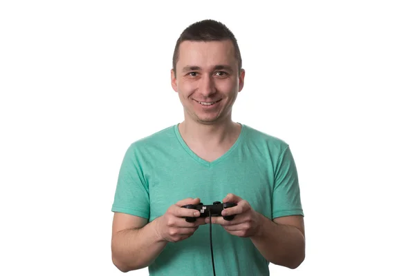 Uomo concentrato giocare ai videogiochi su uno sfondo bianco — Foto Stock