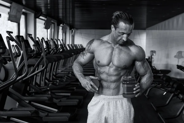 Bodybuilder Posing With Supplements For Copy Space — Stock Photo, Image